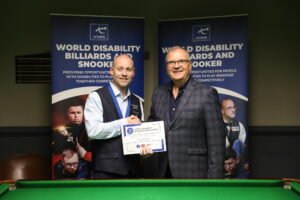 Dave Bolton receives his certificate from WDBS chairman Nigel Mawer during last year's UK Championship