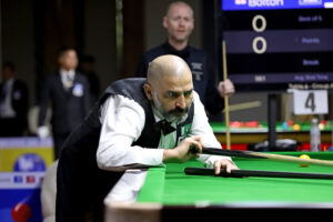 Shahzad Butt plays a snooker shot