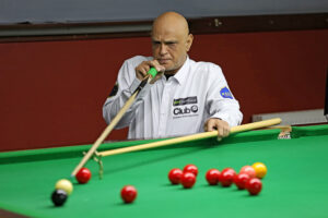 Mahomed Abubaker plays a snooker shot