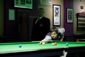 Reece Matin plays a snooker shot
