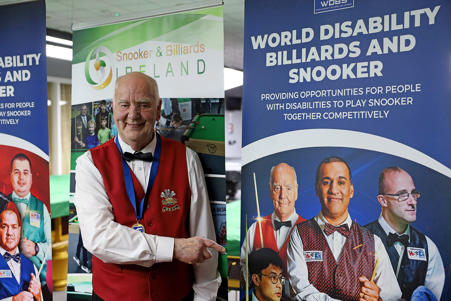 Ronnie Allen with medal and banner