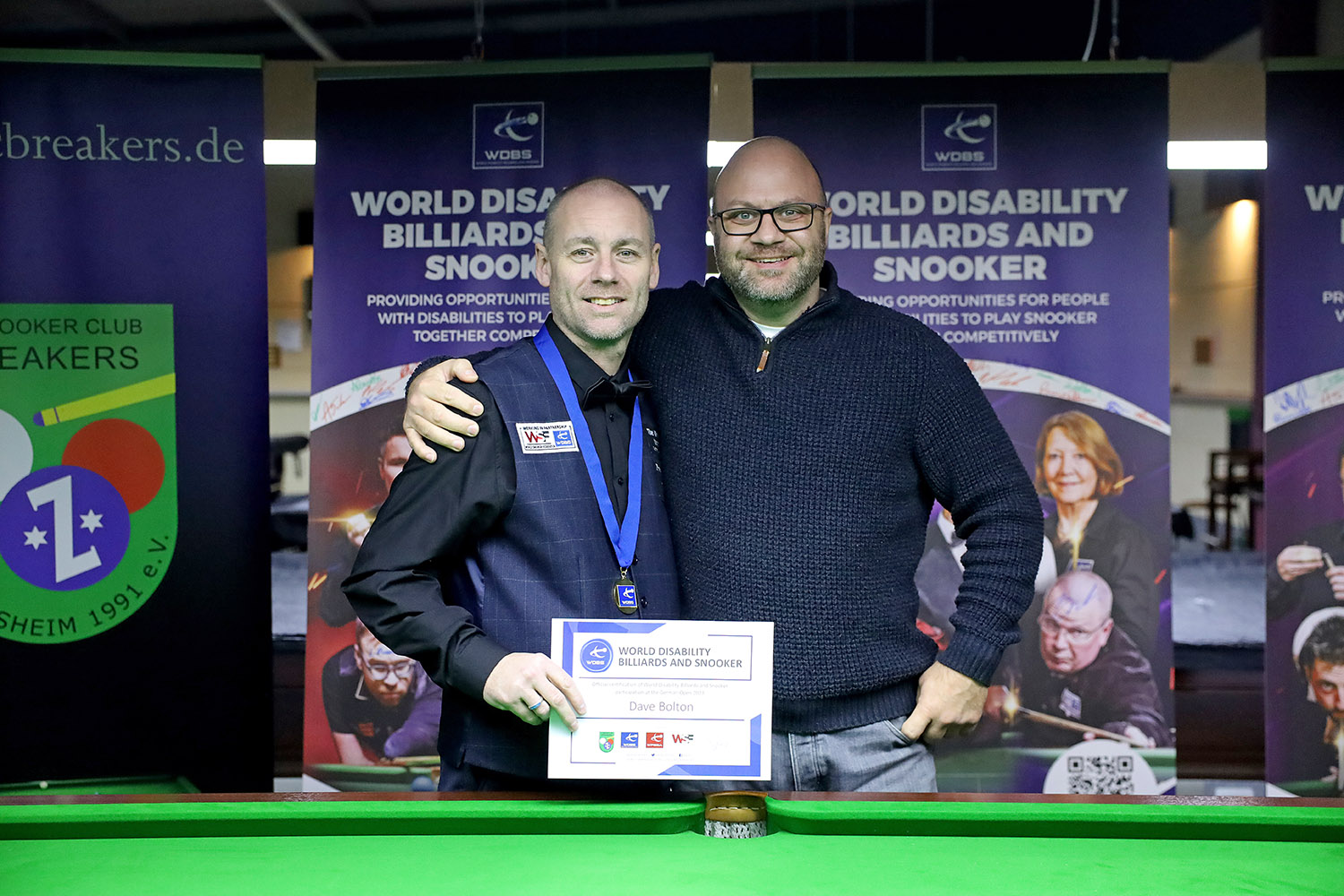 Dave Bolton with friend, gold medal and certificate