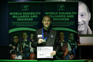 Dave Bolton shows off his medal after victory