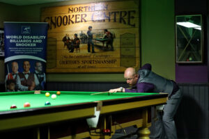 Daniel Booth plays a snooker shot
