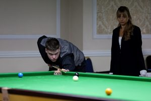 Archie Buskin plays a snooker shot