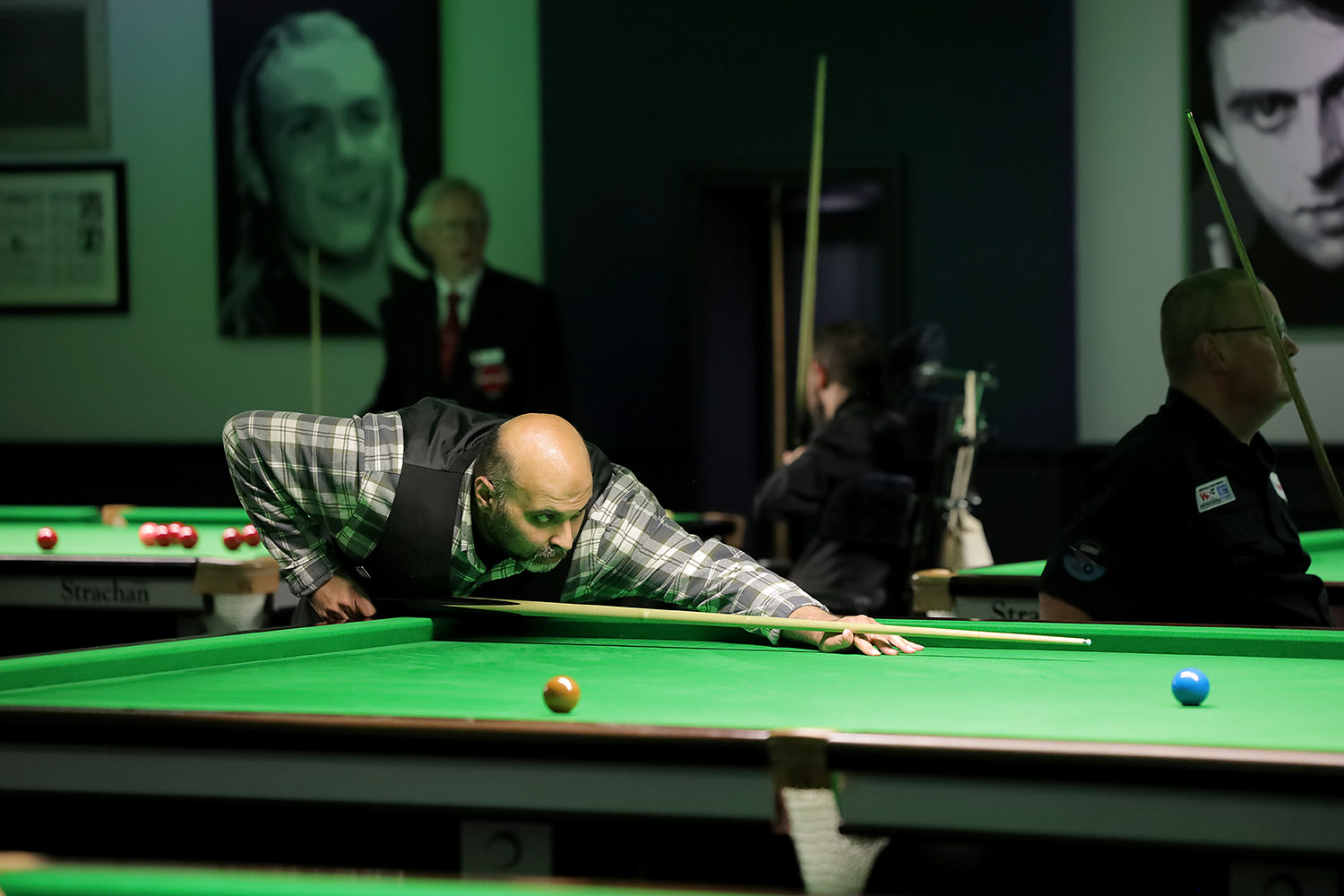 Mohamed Faisal Butt plays snooker shot