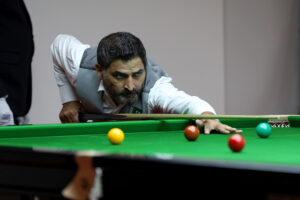 Shahzad Butt plays a snooker shot