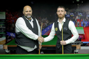 Mohammed Faisal Butt and Ryan Ryding shake hands