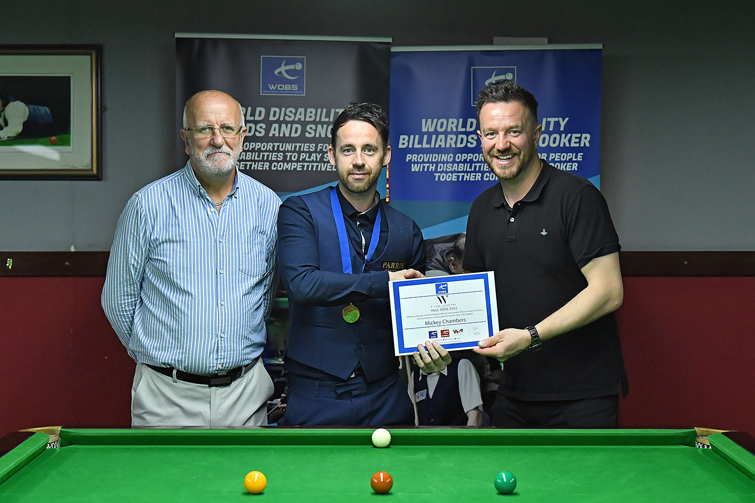 Shaun and Allan Wilson present medal to Mickey Chambers