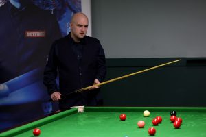Dominic Crookes plays a snooker shot