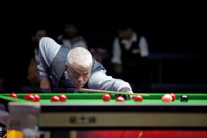 Carl Gibson plays a snooker shot