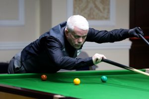 Carl Gibson plays a snooker shot with the rest