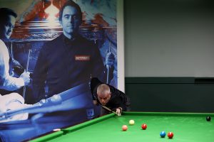 Carl Gibson plays a snooker shot