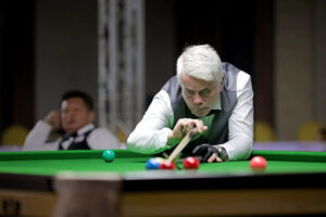 Carl Gibson plays a snooker shot