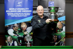 Mike Gillespie lifts the Champion of Champions trophy