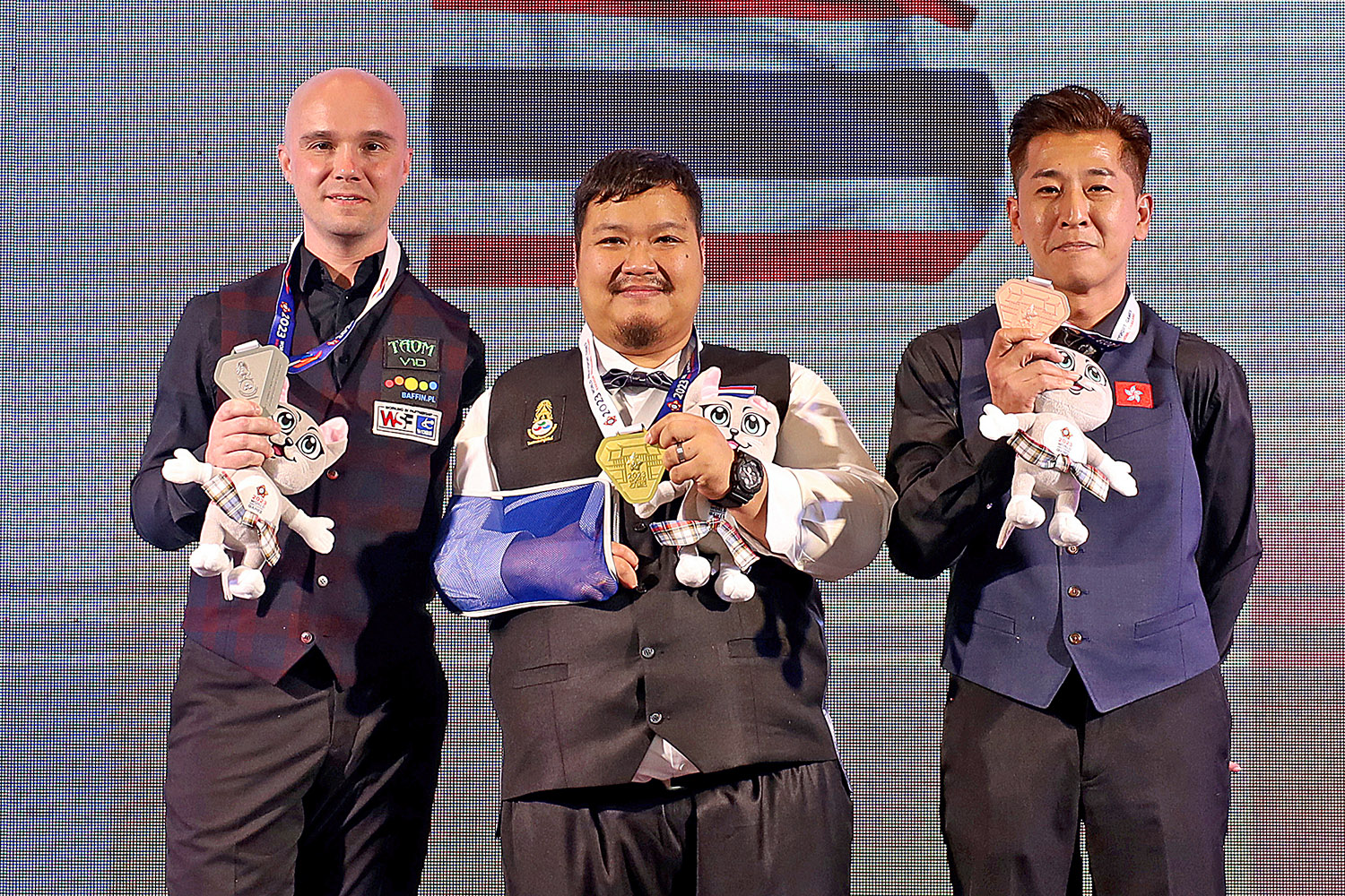 Three players with medals smiling