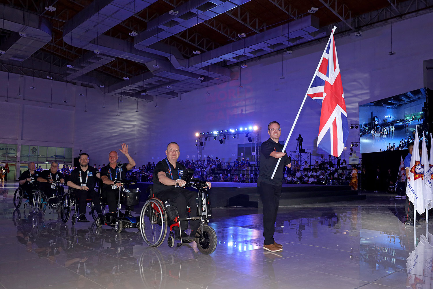 English players smiling holding Great Britain flag at opening ceremony