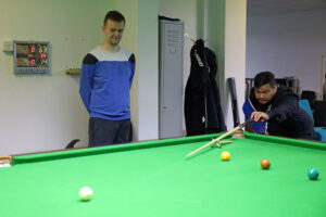 Ashley Hugill watches Thanapol Seekao play a shot at Victoria's Snooker Academy