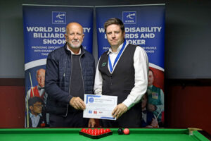 Daniel Kelly receives his medal and certificate
