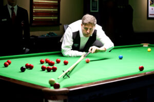 Daniel Kelly plays a snooker shot with the rest