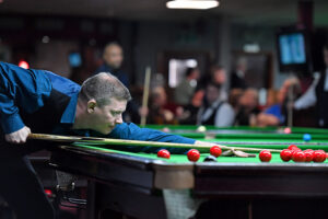 Lewis Knowles plays a snooker shot