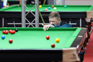 Lewis Knowles eyes up a snooker shot