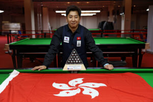 Andy Lam poses with the trophy and the flag of Hong Kong China
