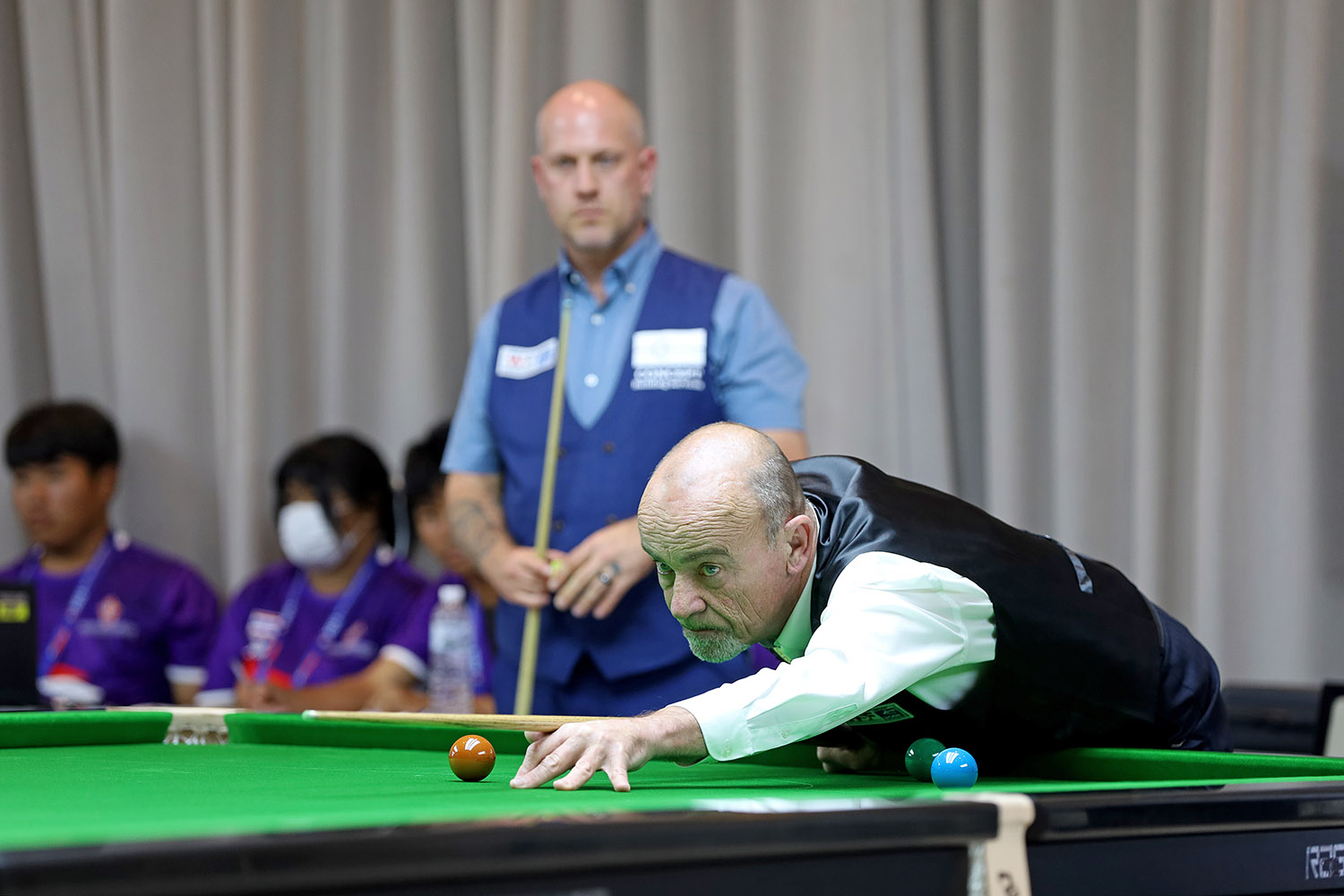 Robert Marriott plays snooker shot and David Moore looks on