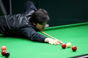 Reece Matin plays a snooker shot