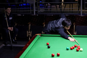 Reece Matin plays a snooker shot
