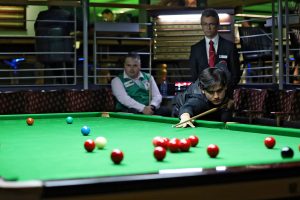 Reece Matin plays a snooker shot