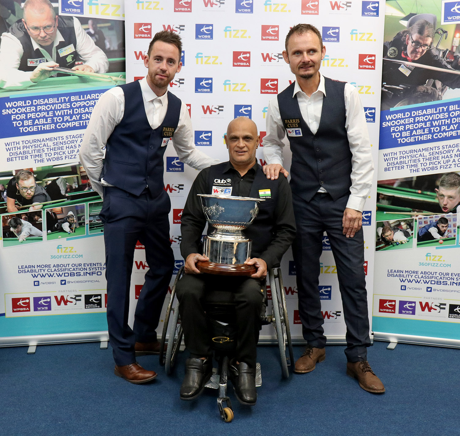 Three snooker players with trophy