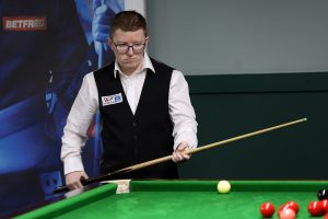Aidan Pollitt plays a snooker shot
