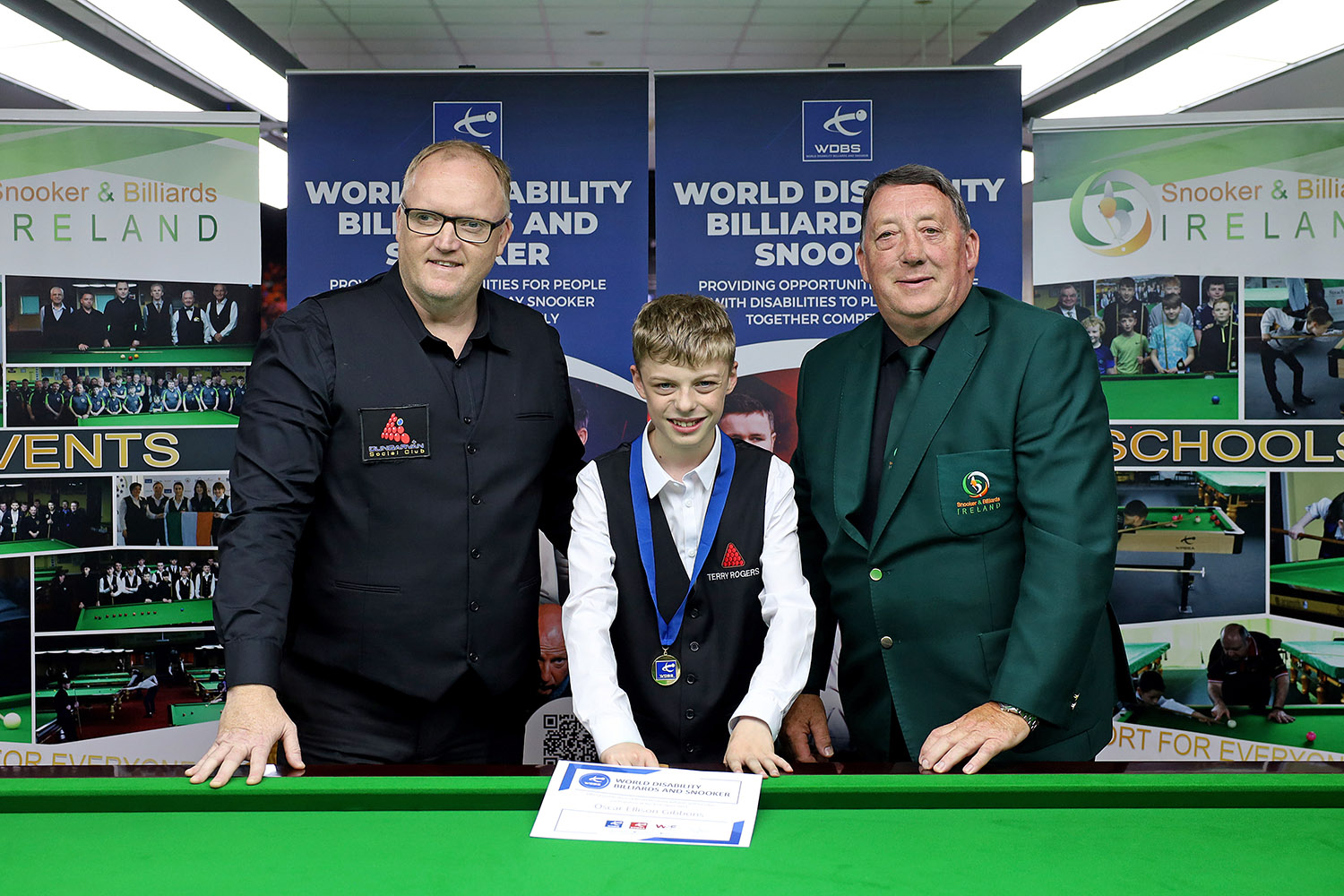 Oscar presented with medal and certificate smiling