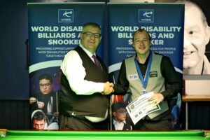 Alan Reynolds shakes hands with Tournament Director James Chambers