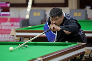 Thanapol Seekao plays a snooker shot