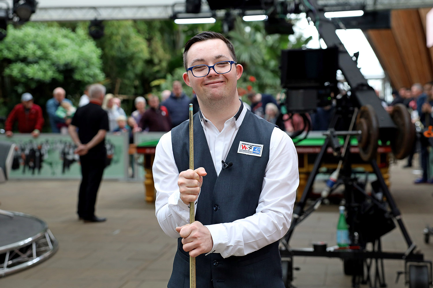 Dylan Smith stood smiling with snooker cue
