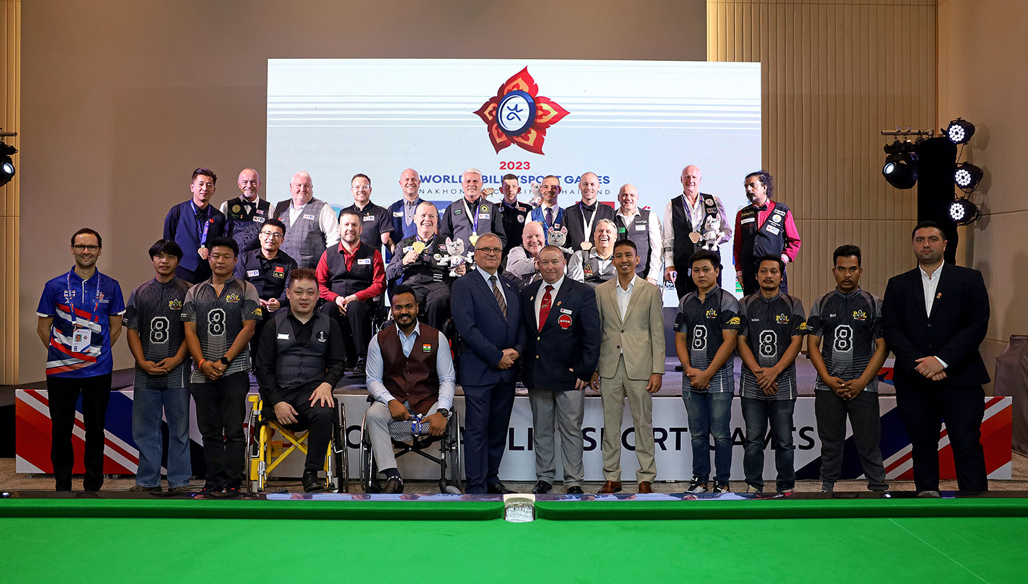 Group of players and staff smiling standing