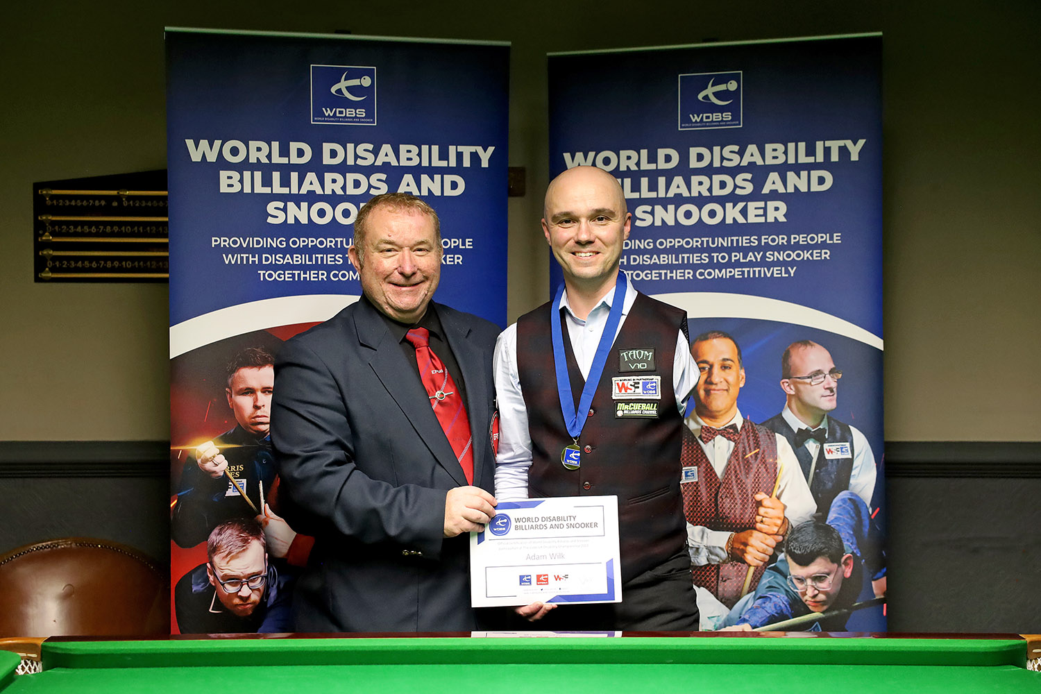 Adam Wilk and Stuart Barker smiling with medal