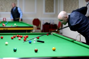 Adam Wilk plays a snooker shot